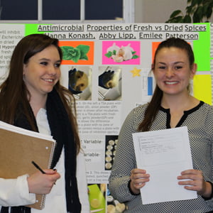 Students in front of display at 2015 First-Year Seminar Symposium