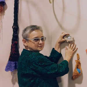 Professor of Art Katharine Kreisher installing her crocheted exhibition, Hekate's Dream, at a gallery in New Mexico.