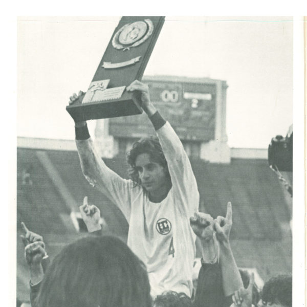 Billy Gazonas holds the trophy after men's soccer wins national championship in 1977