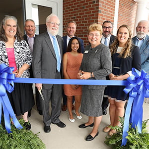 President Durgovich cutting ribbon at new residence community opening