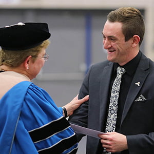 President Drugovich (l) presents an award during 2018 Honors Convocation