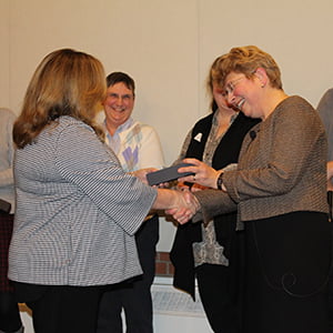 President Margaret L. Drugovich (r) receives her 2018 Quinquennial Award from Director of Human Resources Suzanne Janitz.