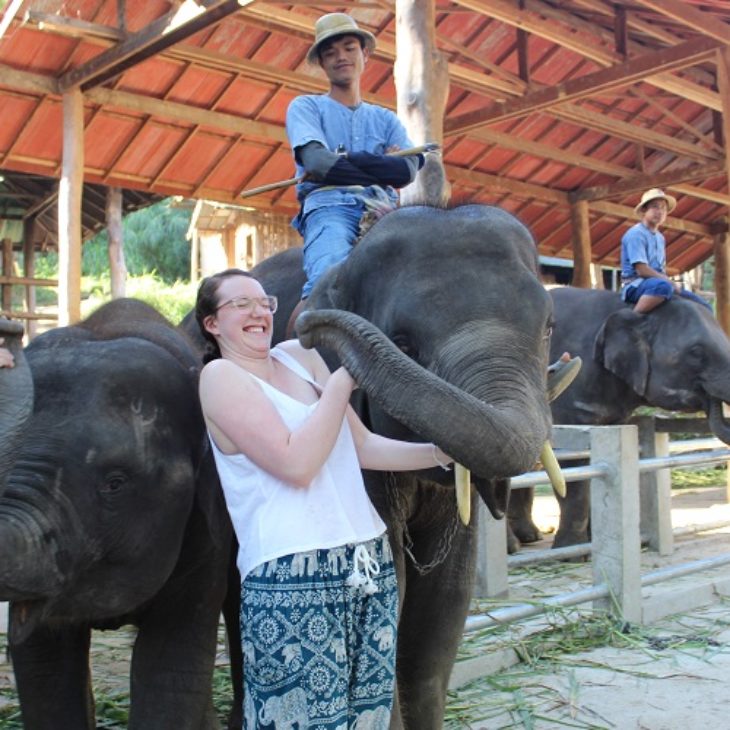 Hartwick student with elephants in Thailand during J Term