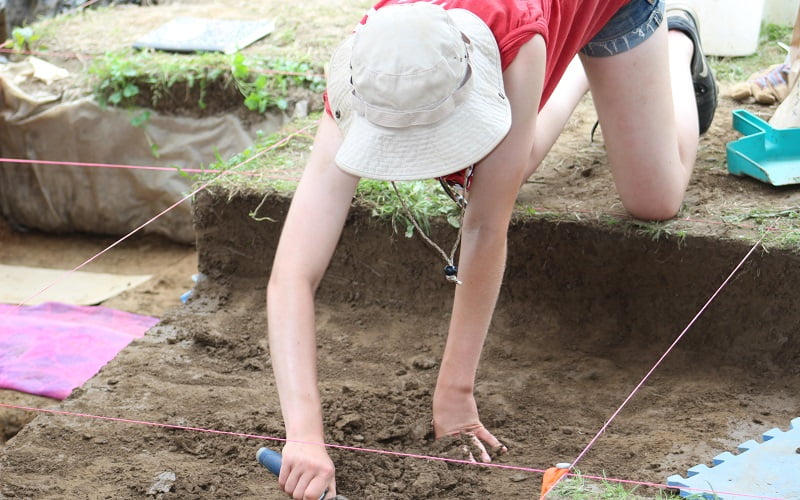 Hartwick College Archaeological Field School student working at dig site