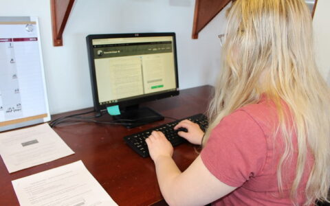 Hartwick student in Writing Center transcribing work of Julia Anna Cooper, a visionary Black feminist