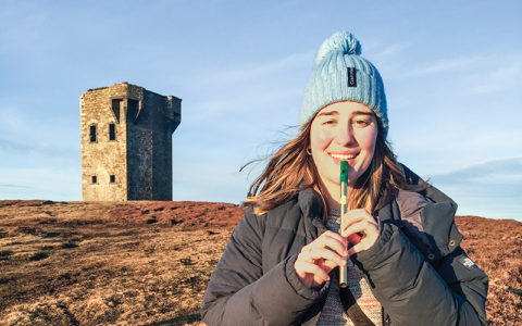 Hartwick music student playing pipe whistle in Ireland