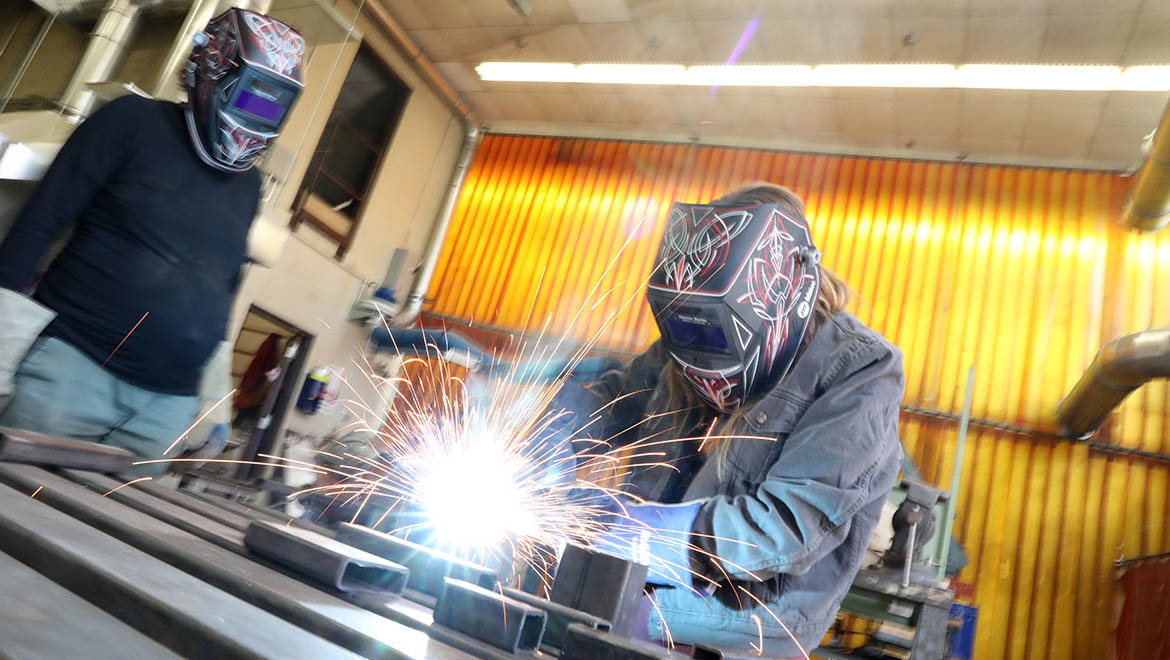 Hartwick College art students welding in sculpture studio
