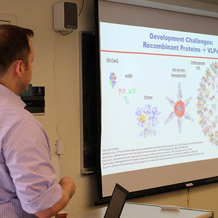 Hartwick College alumnus speaking about biochemical research