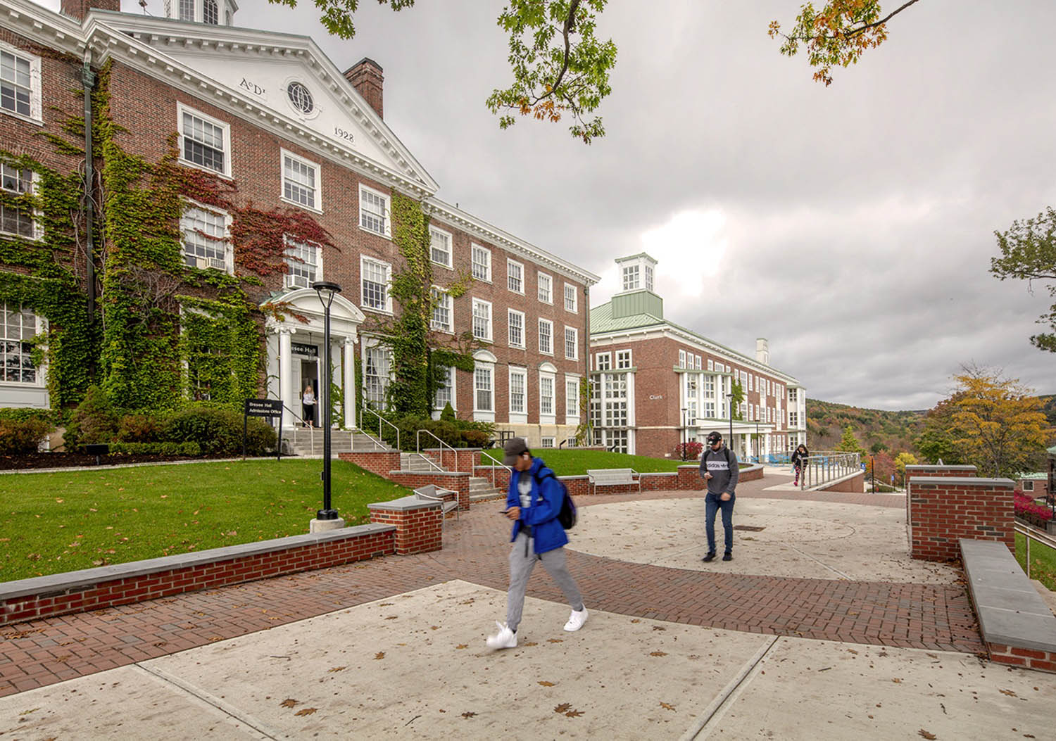 Hartwick College students walking in front of Bresee Hall on Founders' Way