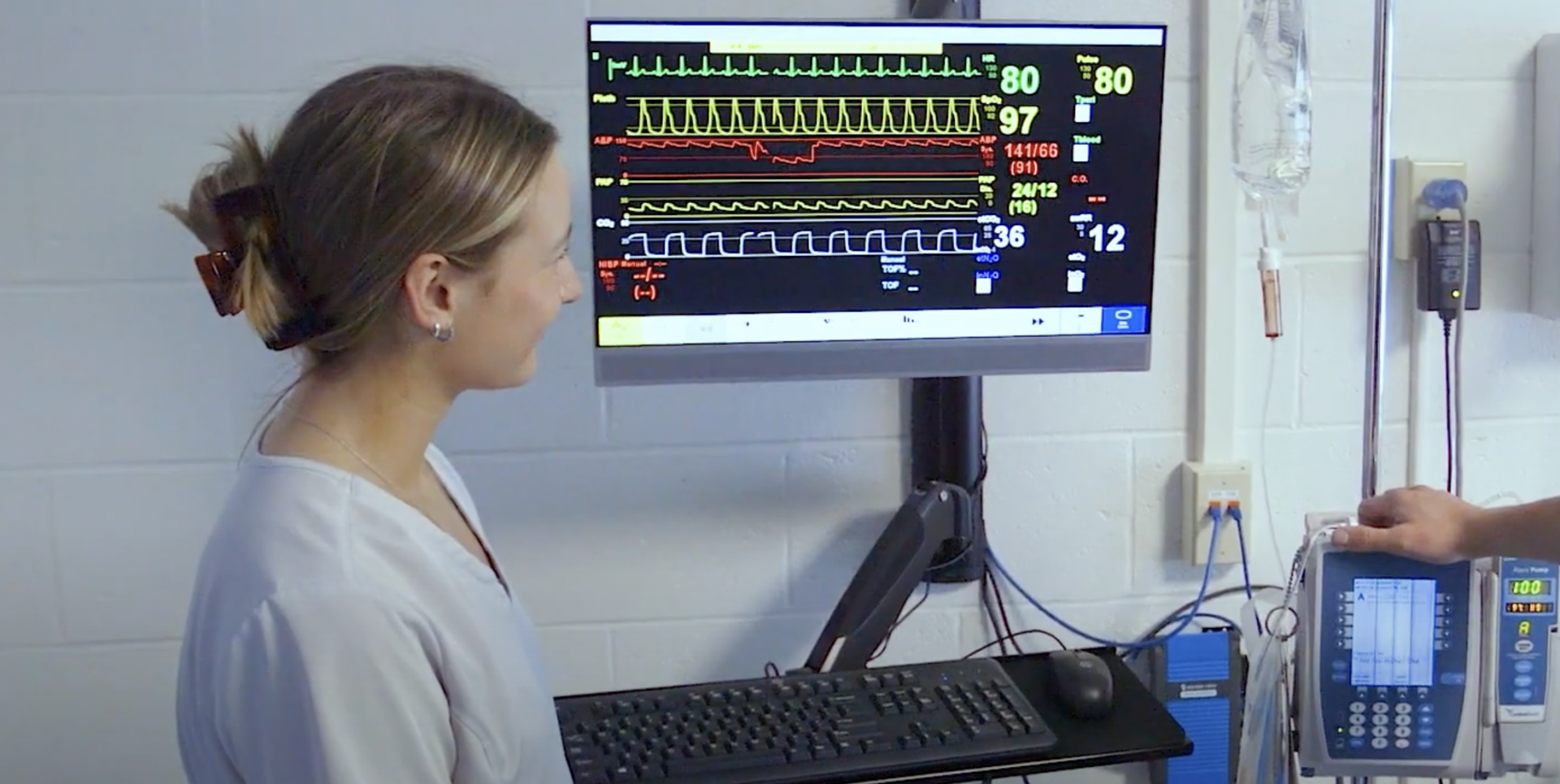 Hartwick nursing students in Nursing Lab looking at vital signs monitor