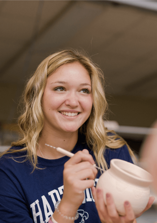 student making pottery