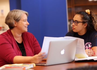 faculty member interacting with student