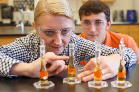Chemistry professor with student looking at water samples for analysis