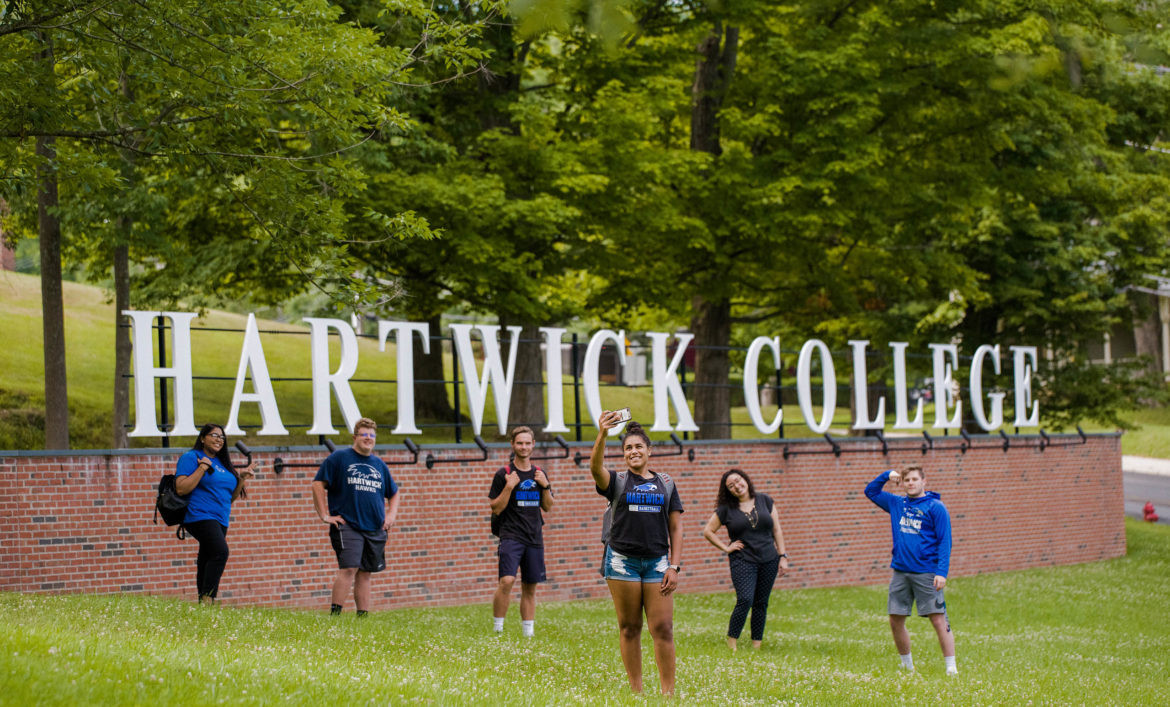 Hartwick students at campus entrance