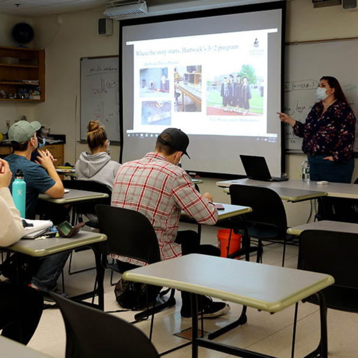 Alumni speaking in science lab class