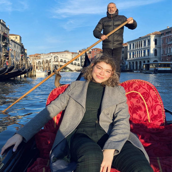 Hartwick student taking a ride in gondola through the streets of Venice, Italy