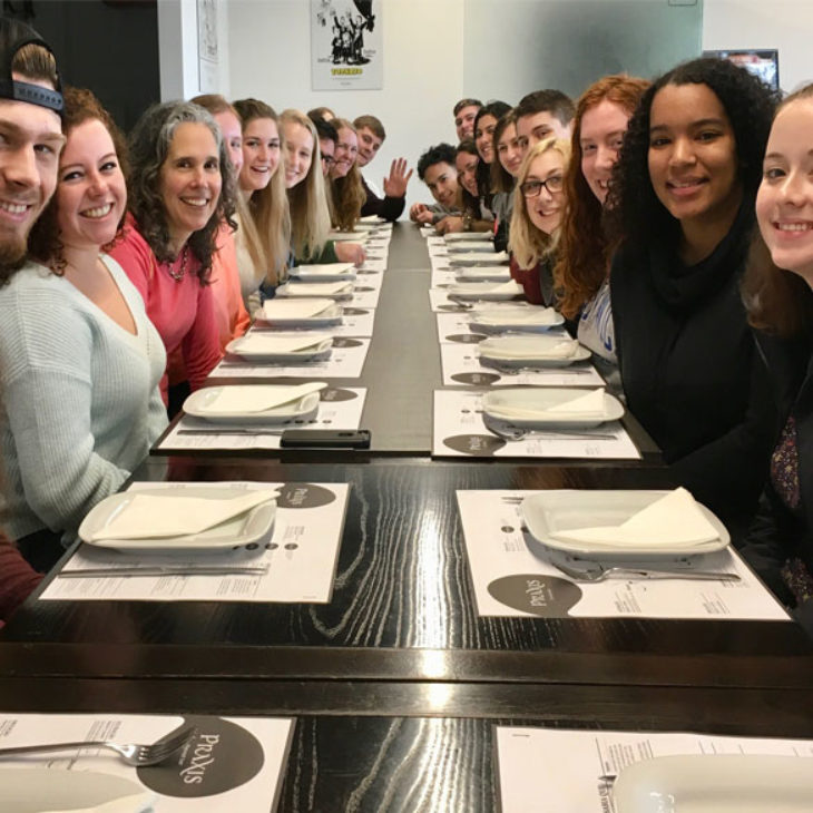 Hartwick students doing praxis abroad eating together at a brewery