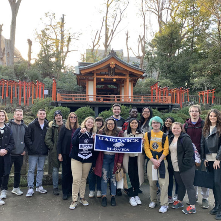 Hartwick students taking a group picture in front of a temple in Nezu Shrine, Tokyo, Japan