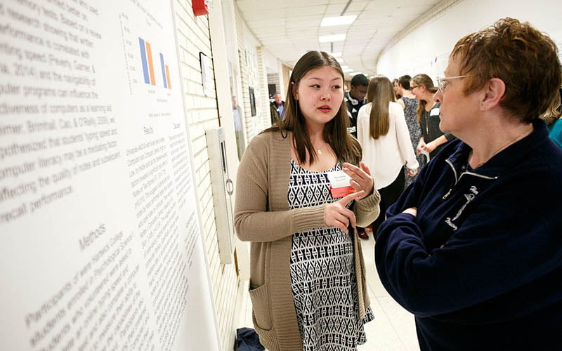 Hartwick College student discussing her research during Student Showcase