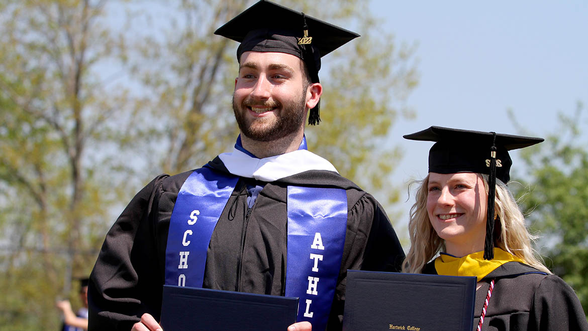 Two Hartwick College graduates after Commencement Ceremony