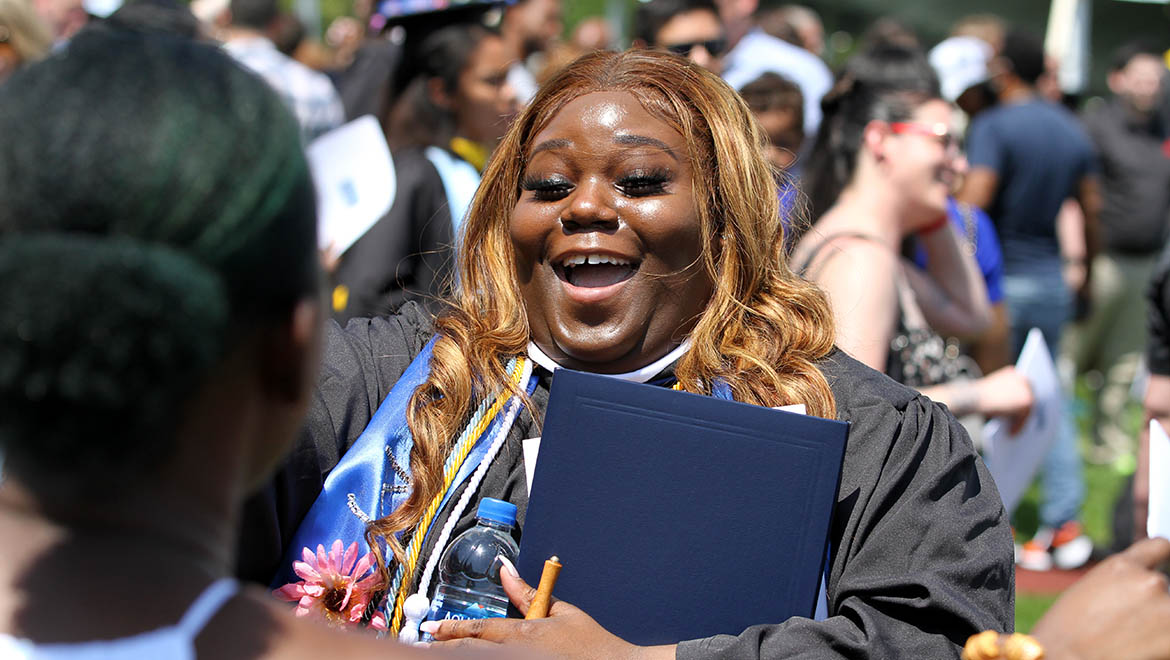 Smiling Hartwick College graduate after Commencement Ceremony