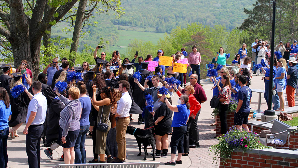 Hartwick College community cheers graduates during Last Walk in cap and gown