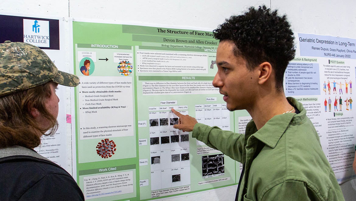 Hartwick College student presenting during poster session of Student Showcase
