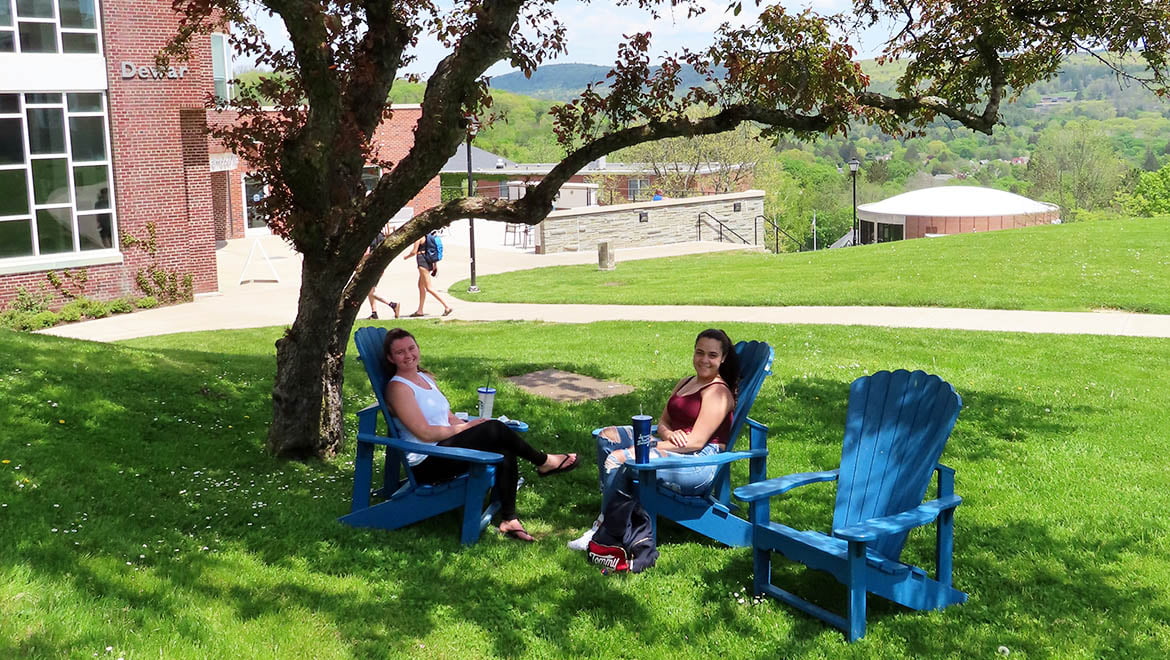 Hartwick students relaxing on campus on a spring day