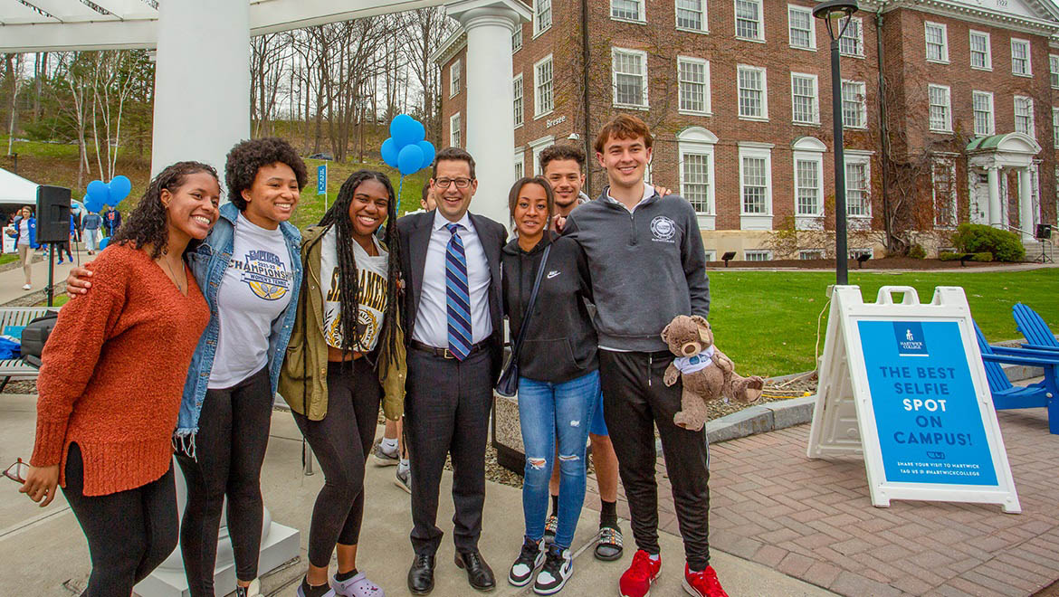 Hartwick College President Darren Reisberg with students on Founders' Way