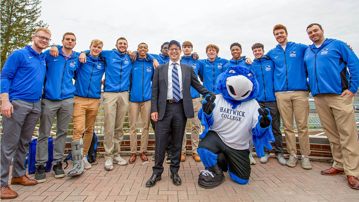 Hartwick College President Darren Reisberg with students and Swoop on Founders' Way