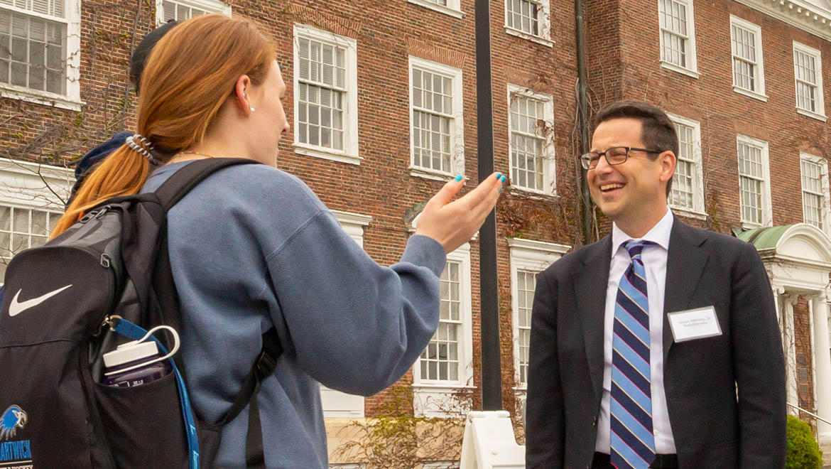 Hartwick College President Darren Reisberg listening to students on Founders' Way
