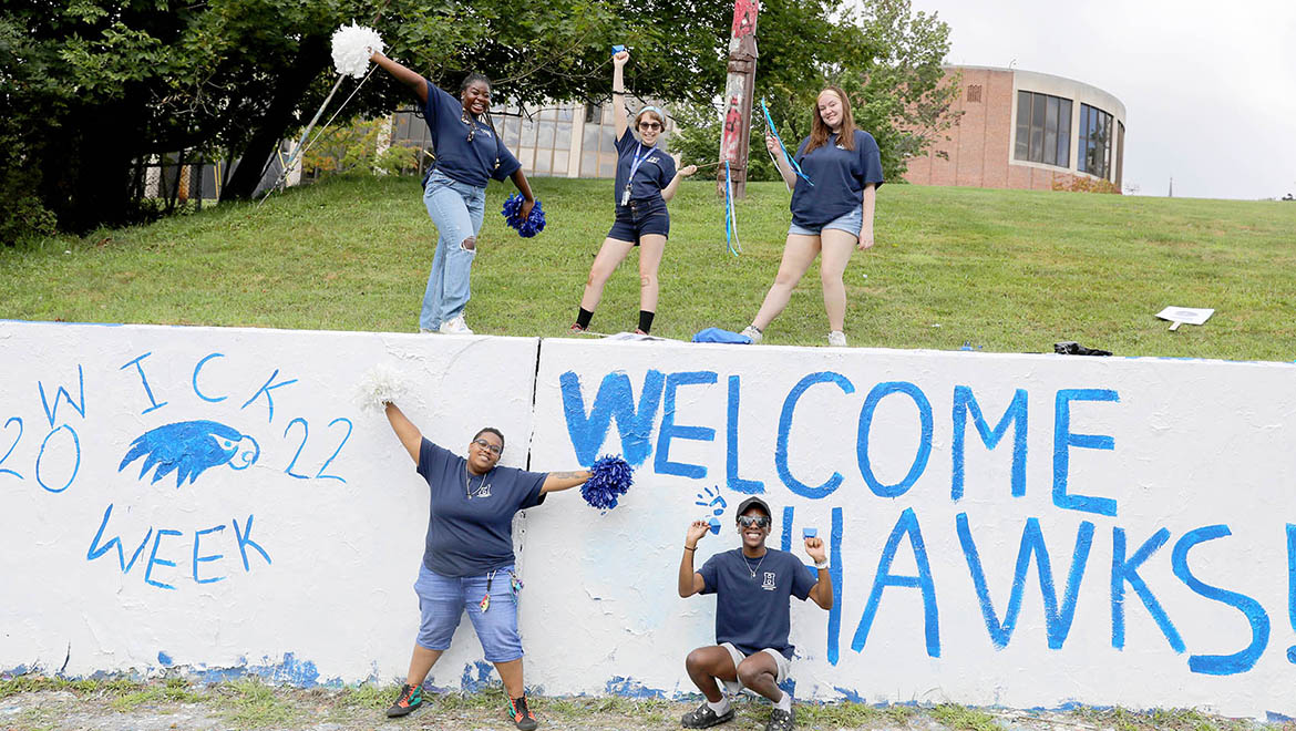 Hartwick students welcome new students at The Wall- painted Welcome Hawks!