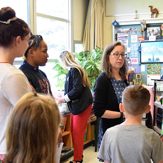 Hartwick College education students with faculty mentor in elementary classroom