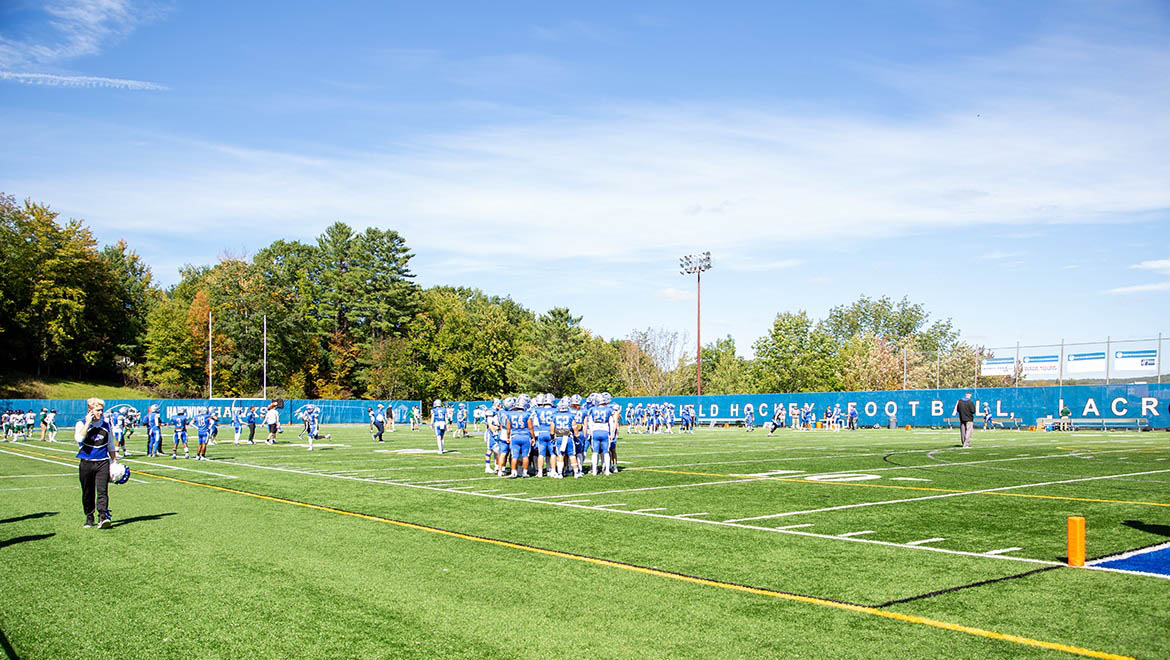 Hartwick College football team on the field during True Blue Weekend 2022