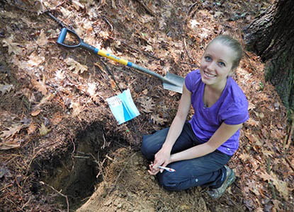 Hartwick College student during soil sampling