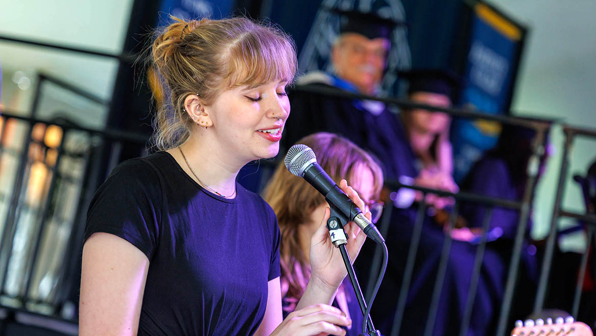 Hartwick student singing during President Darren Reisberg's Inauguration Ceremony