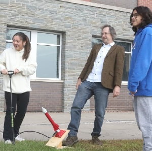 Professor Kevin Schultz with students shooting rockets