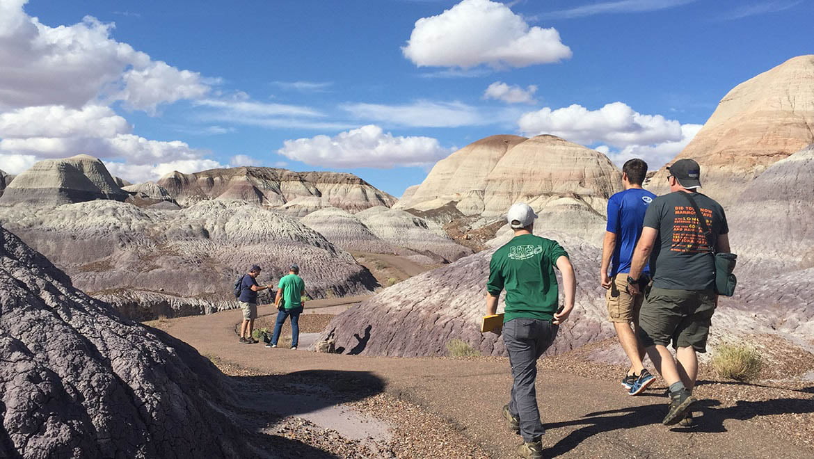 Hartwick College students hiking in field