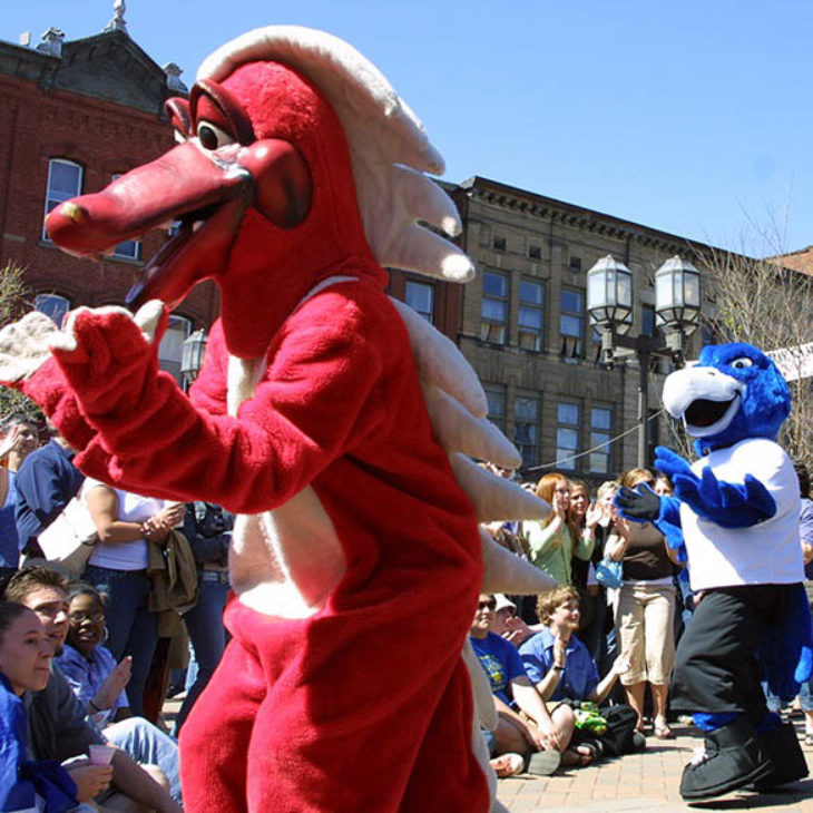 Hartwick College mascot, Swoop, with SUNY Oneonta Dragon mascot on Main Street during OH Fest