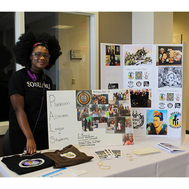 Hartwick College student member of SOSU BU with display boards