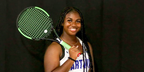 Hartwick College student with tennis racket