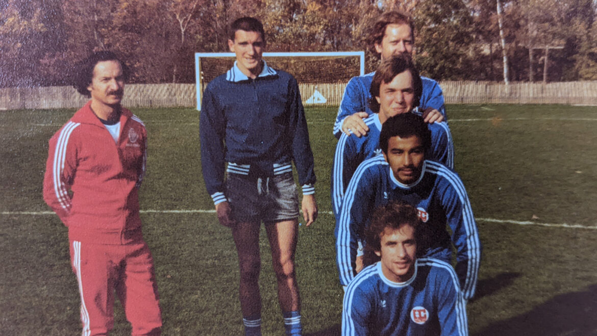 Hartwick College men's soccer coach Jim Lennox with players on field