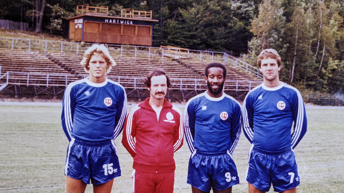 Hartwick College men's soccer coach Jim Lennox with players on field