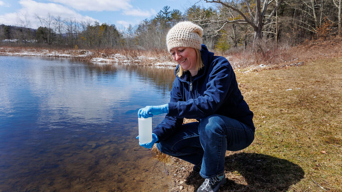 Professor of Geology Zsuzanna Balogh-Brunstad with water sample at Hartwick College's Pine Lake Environmental Campus