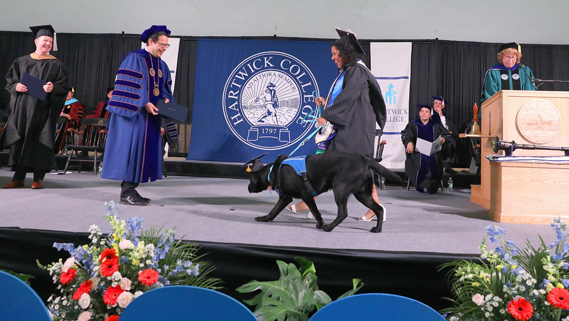President Darren Reisberg with graduate and Guiding Eyes Puppy