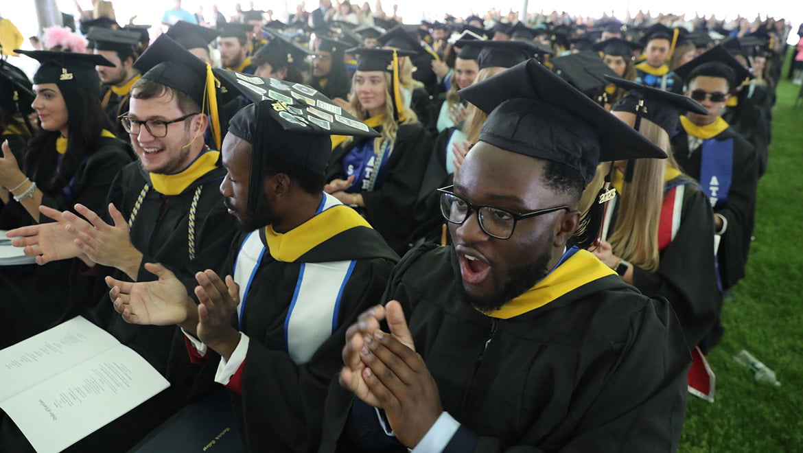 Hartwick College graduates clapping