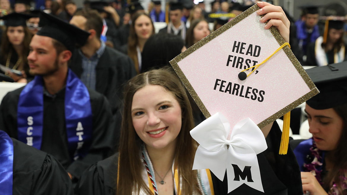 Hartwick College graduate showing the top of her cap with inspirational message before Commencement ceremony begins