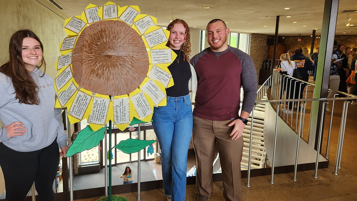 Hartwick College nursing students with sunflower