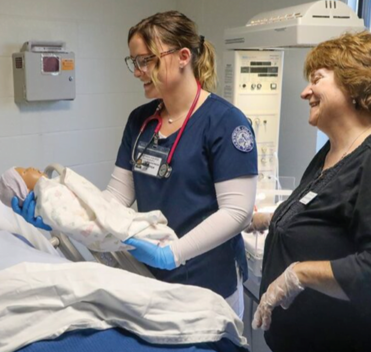 Hartwick College nursing student with faculty member in birthing simulation lab