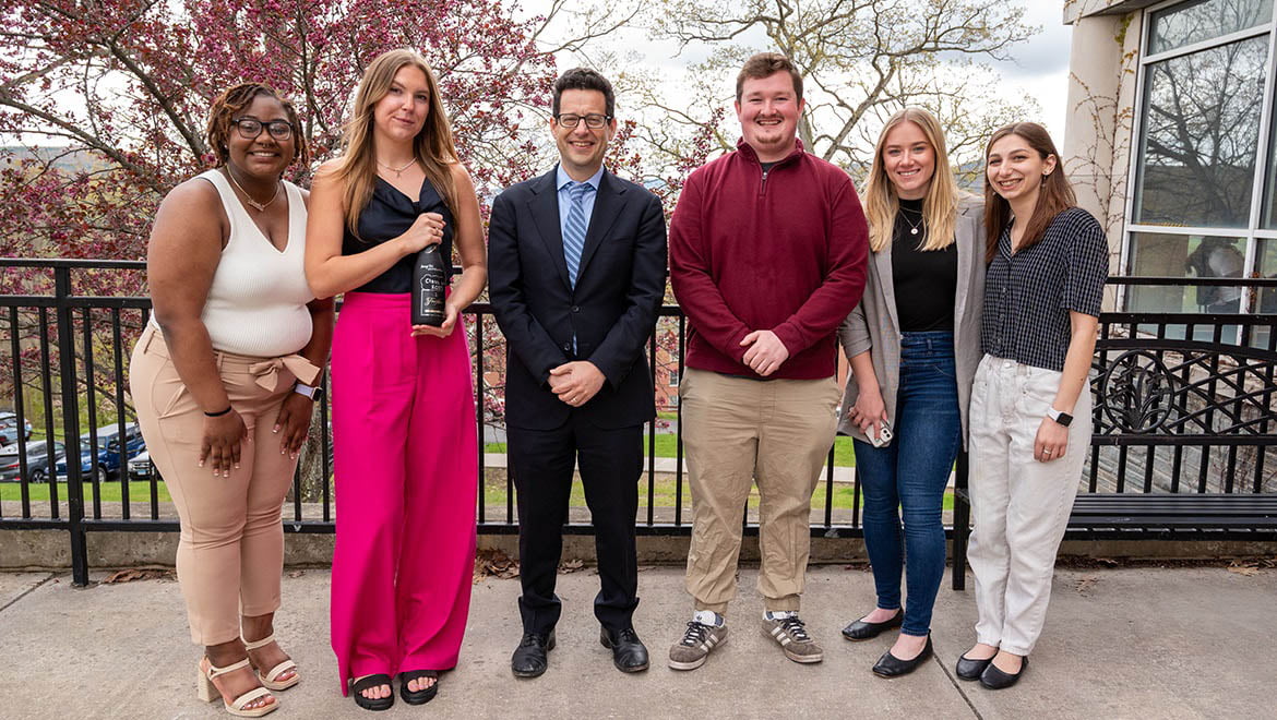 Hartwick College President Reisberg with senior students after they presented research during Student Showcase 2023